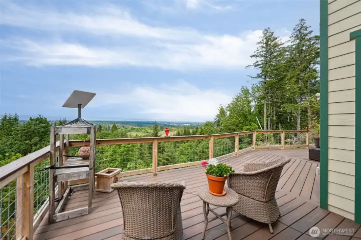 From this western-facing perspective, you really start appreciating how thoughtfully positioned this home is within the landscape because the soaring pine trees surrounding the property create incredible privacy and that immersive forested mountain atmosphere people crave, while still sitting far enough from the home itself to avoid feeling crowded or concerning during heavy wind and storm seasons. Perched high above the surrounding terrain, the property also becomes a fantastic place to take in local wildlife with bald eagles frequently visible overhead along with all the quiet natural beauty that comes from living atop 20 private acres. Structurally, this home was also built with serious intention because the already bedrock-based site was further reinforced by pinning the foundation directly into the rock itself, creating remarkable stability & durability beneath the home. Combined w/the fire-resistant HardiePlank siding & metal roofing system outside, the property carries strength.