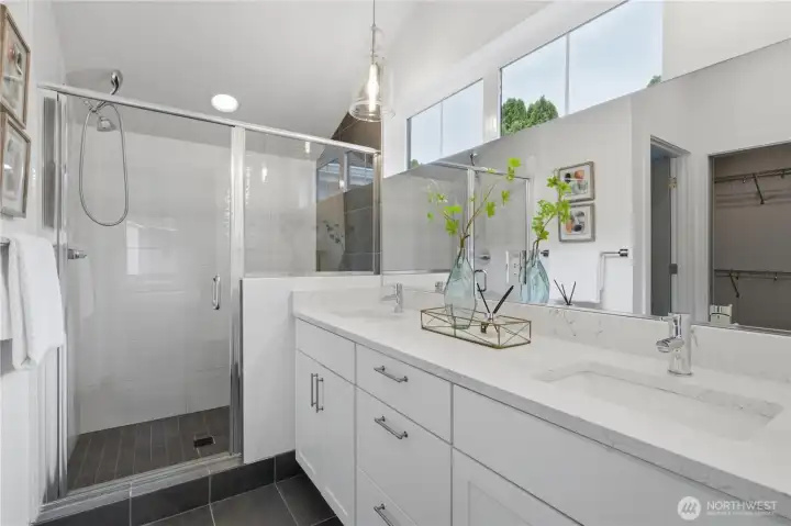 Primary bath with dual vanity and large walk-in shower.