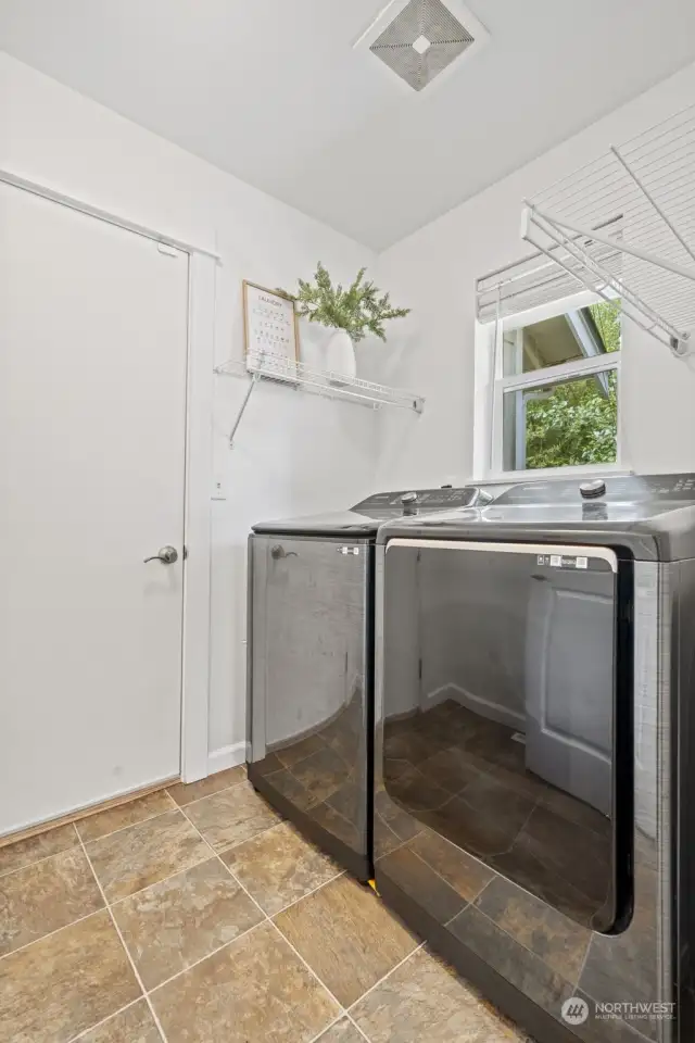 Main floor utility room with storage on the other side