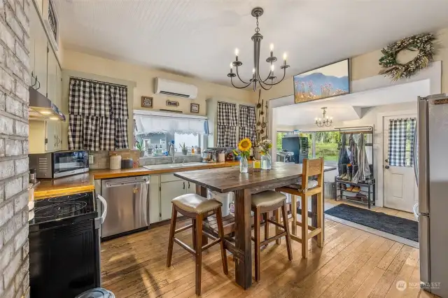 Another view of the kitchen. The mud room can be seen to the right. Notice the mini-split for added comfort.