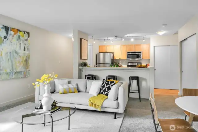 Overlooking it all is a stylish open kitchen with breakfast bar.
