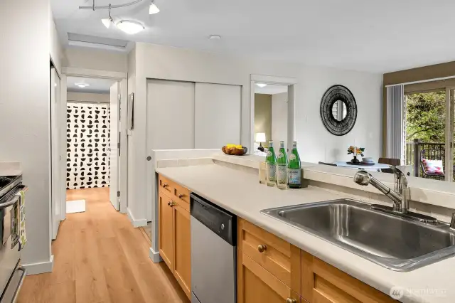 New luxury plank flooring flows through the kitchen, hallway & bath.