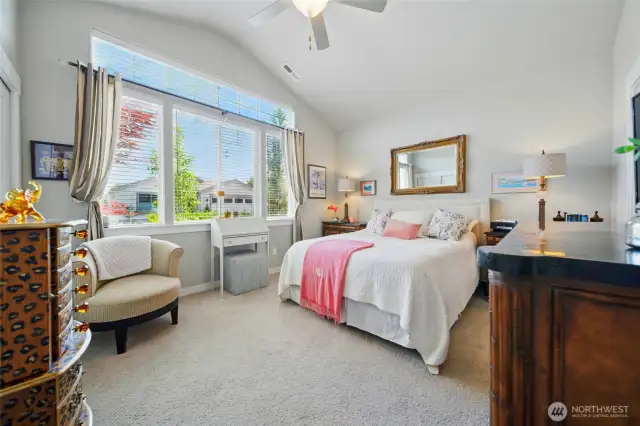 Primary bedroom with vaulted ceiling