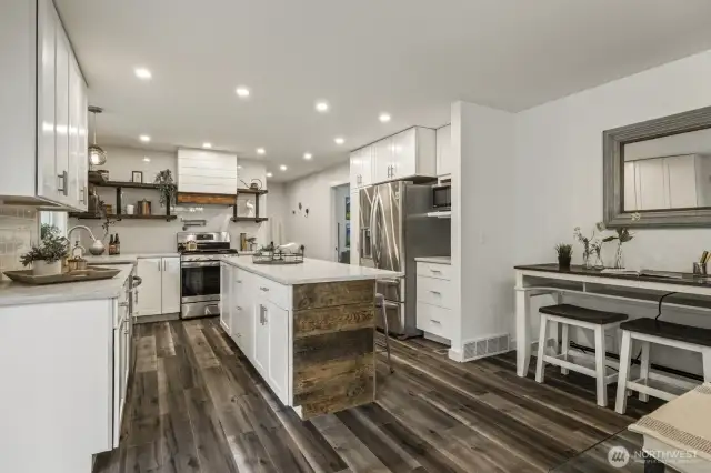 Expansive kitchen offers a flexible bump-out area designed for work, homework, or hobbies.