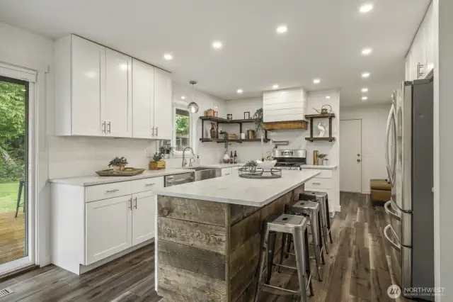 Bright and modern kitchen with white cabinets, sleek quartz surfaces, and a generous island.