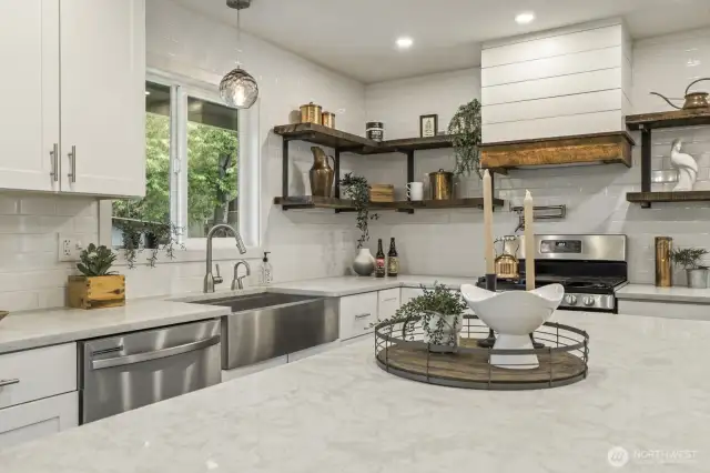Chef’s kitchen equipped with stainless steel appliances, gas stove, and convenient pot filler