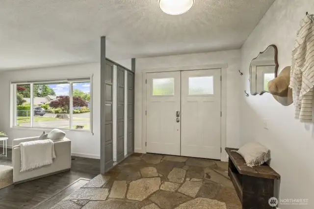 Stylish slate tile and double front doors set the tone in this spacious, welcoming entryway.