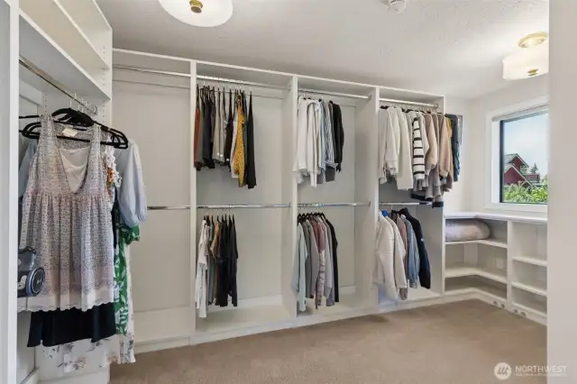 Custom walk-in closet delivers wow-factor storage—featuring built-in shelves, extensive clothing racks & dedicated shoe storage to keep everything organized & within easy reach