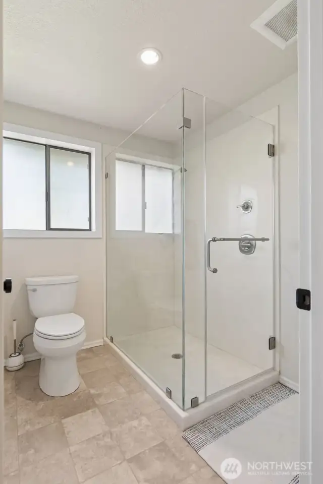 Primary suite bath features a walk-in shower, stylish finishes & a spa-like vibe—designed for daily comfort & a touch of luxury