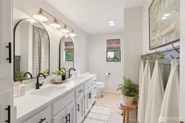 Upstairs shared bath blends sleek modern style w/ a double vanity, upgraded finishes & plenty of counter space—perfect for busy mornings or relaxed evening routines