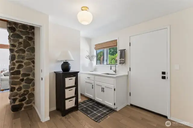 Main floor mudroom offers a private entry point—perfect for coming in from the outdoors to drop gear, freshen up, & keep the rest of the home clean & organized