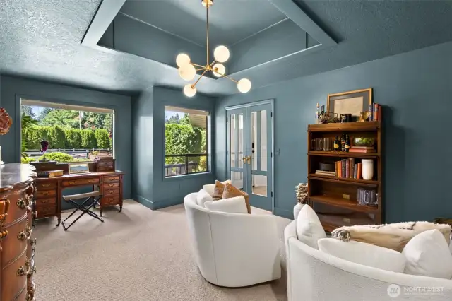 Versatile 5th bedroom on the main level doubles as a stunning office—featuring elegant French doors, expansive windows, & abundant natural light. The perfect blend of function & style.