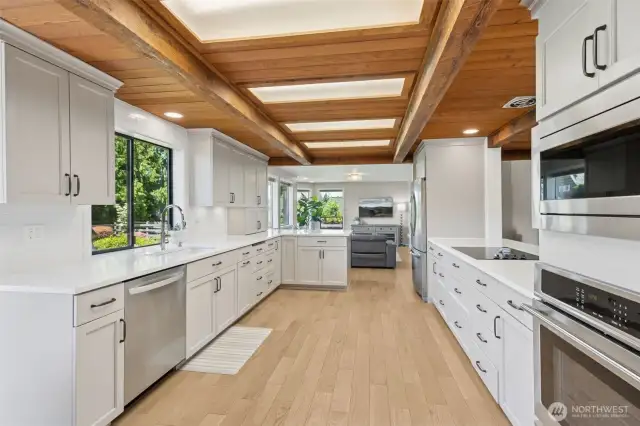 Open-concept kitchen features sleek wall ovens, an inset cooktop, & seamless flow into every area of the home—designed for effortless living & entertaining