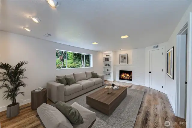 Large rec room with fireplace and new LVP flooring