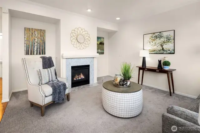 Family room adjacent to kitchen features a cozy gas fireplace.
