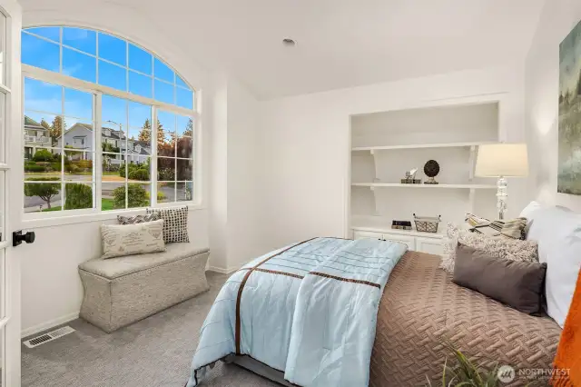 Opposite the bed are built in shelves and cabinets which very easily can be converted into a closet, making this a perfect 5th bedroom on the upper level (making this a 6 bedroom home).