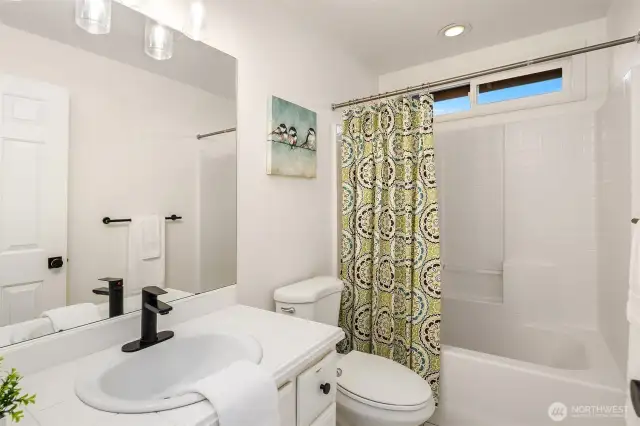 Full bath off hallway on upper level.