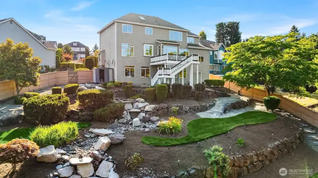Another view of the backyard with its rock garden and pond.