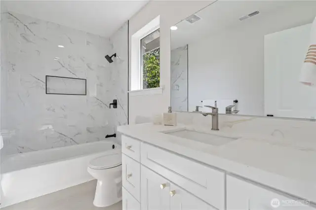 Modern full bathroom with updated fixtures and clean finishes