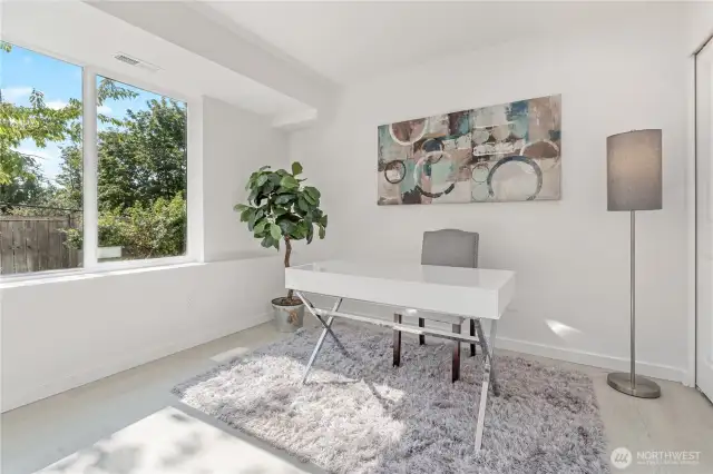 Lower-level third bedroom filled with natural light—perfect for guests or office space