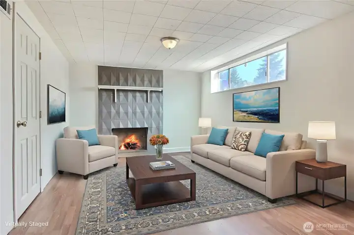 Downstairs family-room has so much potential. Imagine evenings with a warm fire. Virtually staged photo, does not reflect owners personal items.