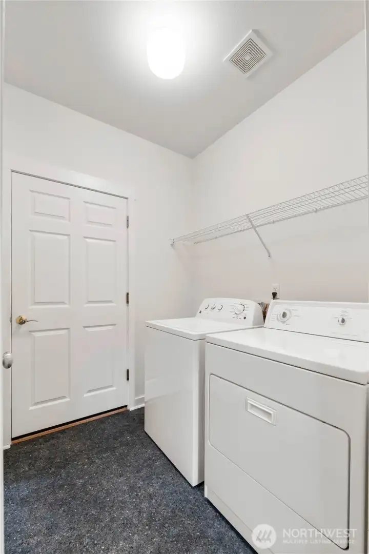 Laundry room with garage door access and pocket door to the kitchen