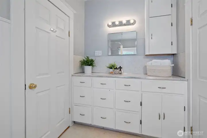 The generous main-level bath is ideally positioned between two bedrooms and offers abundant storage on one side of the bathroom. . . .