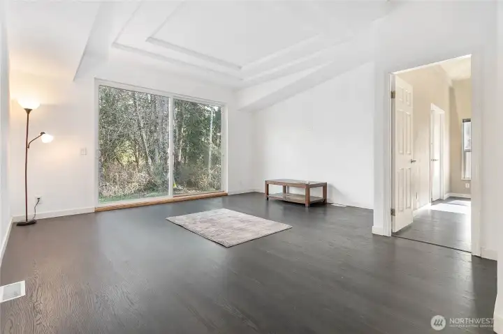 Living room with oversized sliding doors to backyard