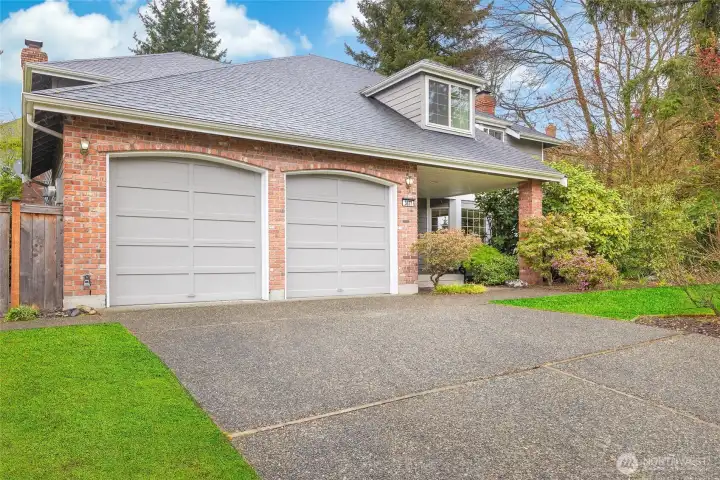 Two-car garage with spacious driveway.