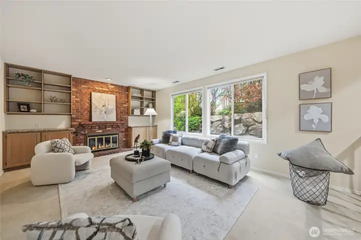 Family room with wood-burning fireplace and built-in shelves.