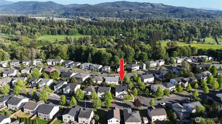 Arial view of the house in the middle of the community (looking east). Arial view of the house in the middle of the community (looking east).