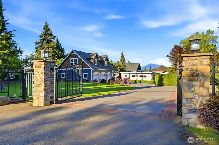 Gated entry with red paver, circular driveway.