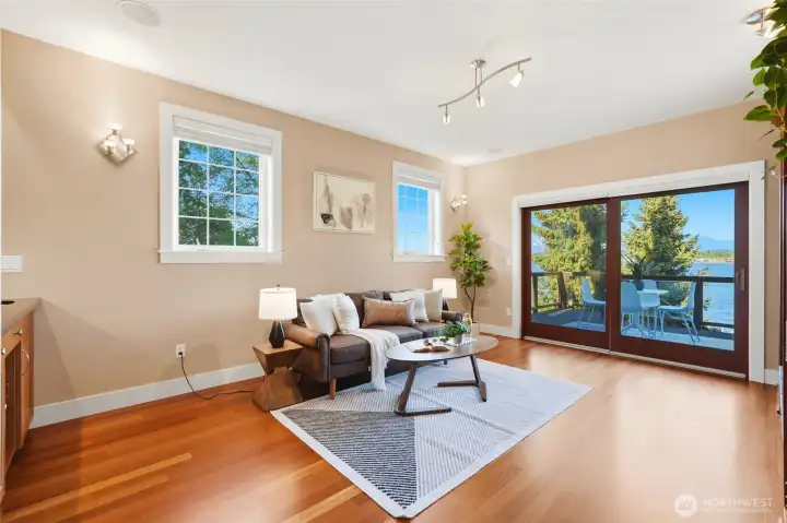 Sitting room with a wet-bar, built-ins, fireplace and slider to the deck.