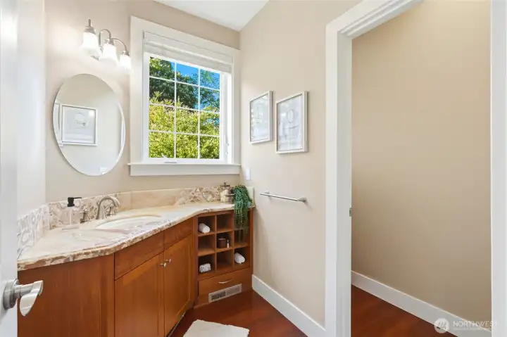 Main floor powder room with private water closet.