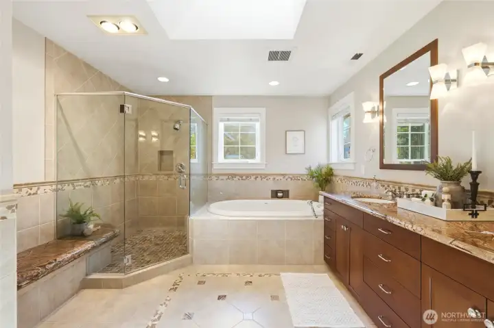 Primary en-suite with heated floors, jetted tub, large walk-in shower & double vanity with granite counters.