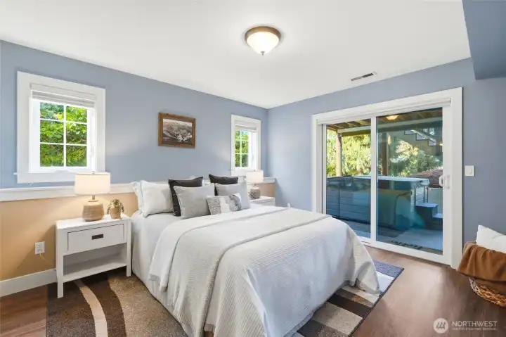 Basement level bedroom with sliding glass door to the hot tub and patio area.