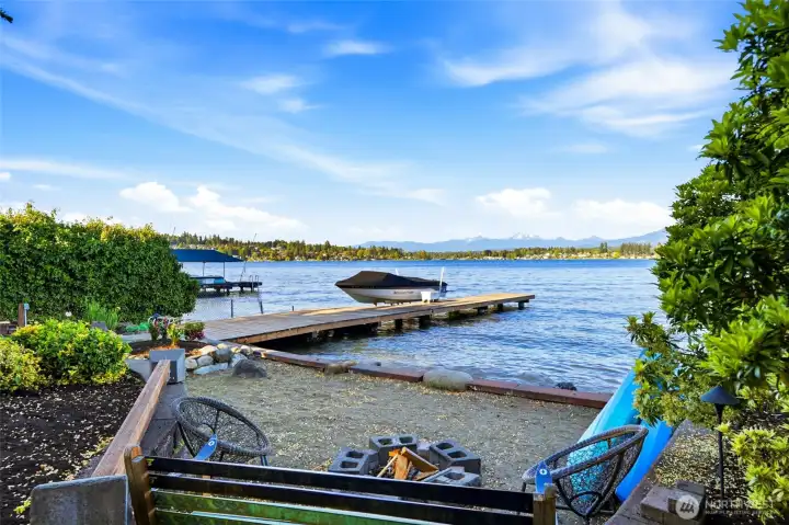 It even has a sandy beach area with a fire pit and a bench for chilling.