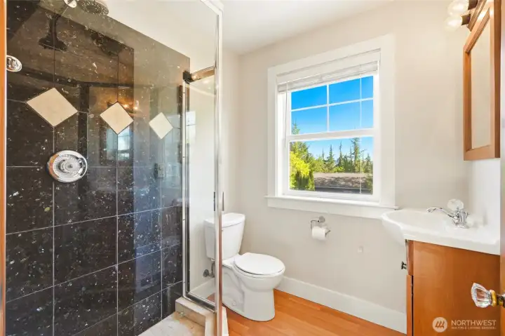 Apartment bathroom with walk-in shower.