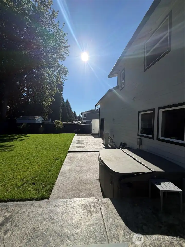 Custom concrete back patio with hot tub included Custom concrete back patio with hot tub included