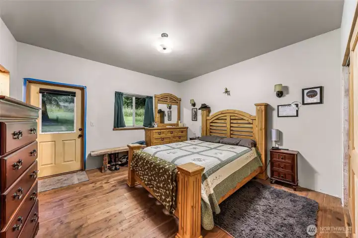 Primary bedroom with a door to the deck and hot tub. Primary bedroom with a door to the deck and hot tub.