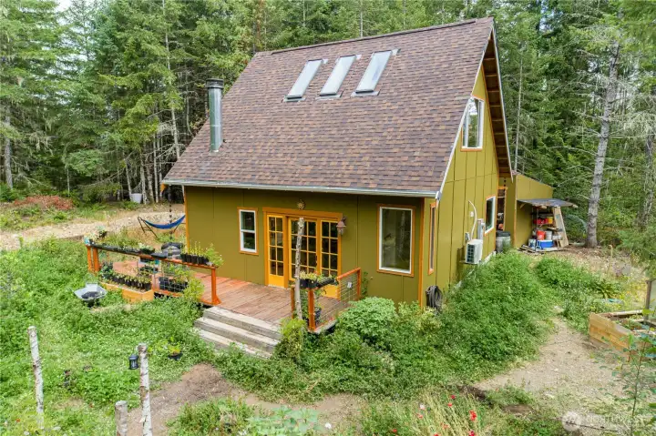 The home sits at the heart of an intentionally cultivated landscape, where gardens meet the forest.