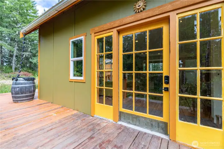 The welcoming front entrance features salvaged historic doors from a Portland building, adding character and craftsmanship that's impossible to replicate.