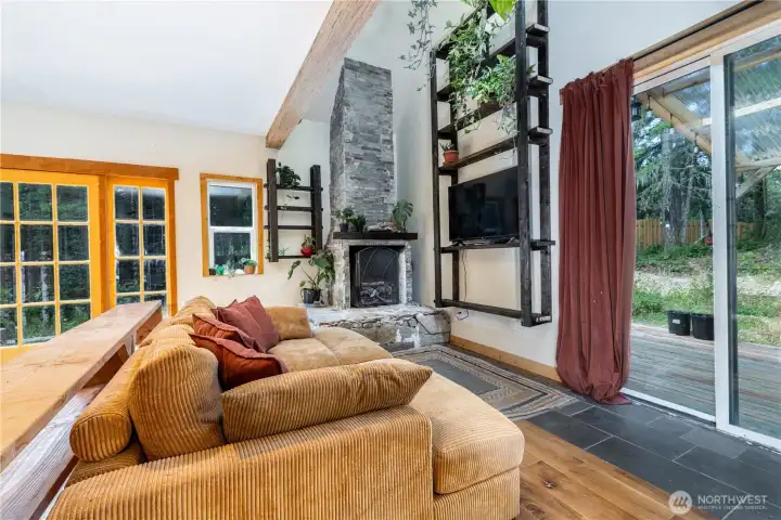 Expansive sliding glass doors blur the line between indoors and out, filling the living space with natural light and opening directly to the covered deck.
