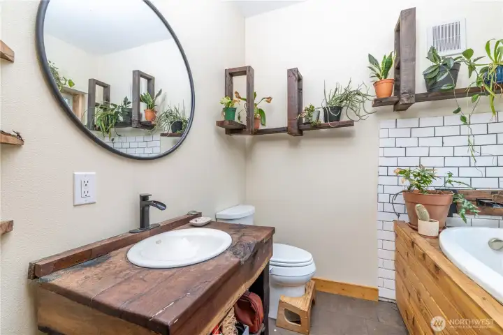 The custom live-edge vanity and handcrafted woodwork continue the home's one-of-a-kind design from floor to ceiling.