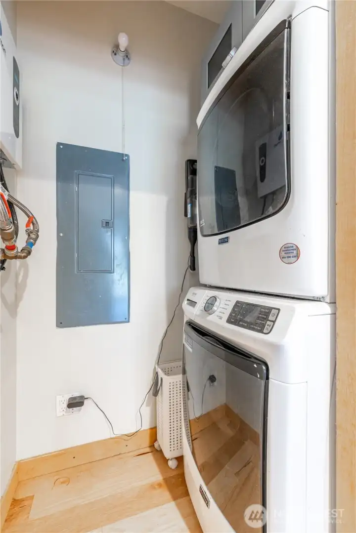 Convenient laundry area with stacked washer and dryer, thoughtfully tucked away to maximize living space.