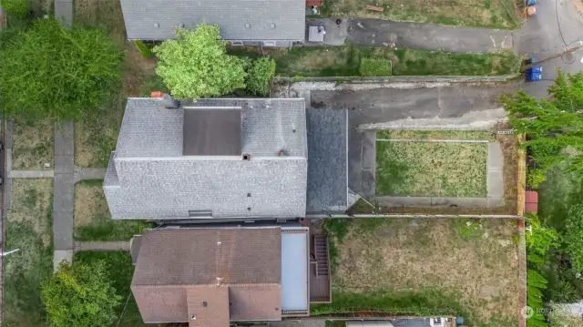 Aerial showing lot size including alley access to driveway.