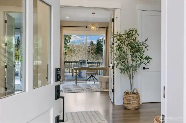 A covered porch welcomes you into the home, with light pouring in from all sides.