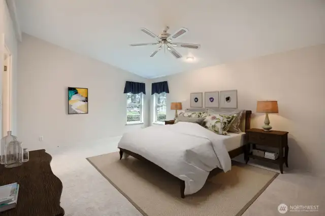 Primary suite offers a walk-in closet and views to the waterfall and lovely landscaping of Water Gardens.   *virtually staged