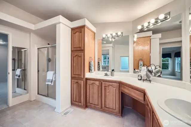 This primary bath offers a shower with a convenient bench for comfortable showering.