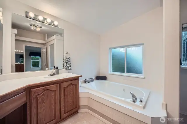 Another highlight of this spacious primary bath is a soaking tub.